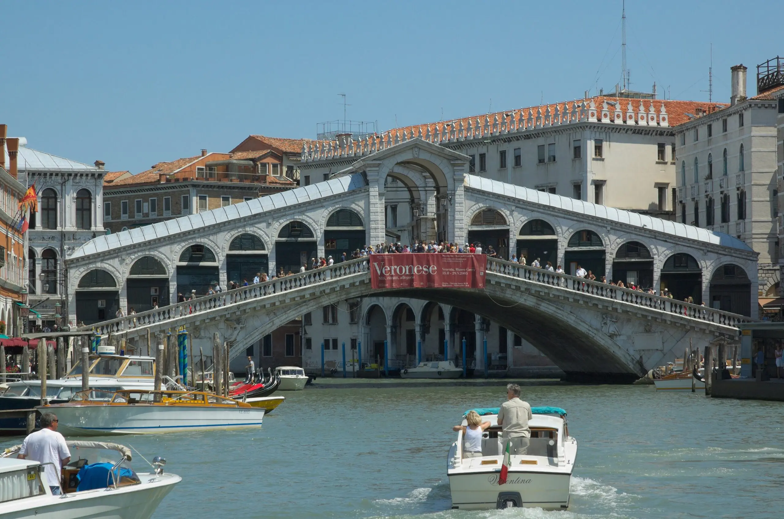 Authentic photograph of Rialto Bridge and water taxis on the Grand Canal in Venice, above the historic Rialto commercial quarter