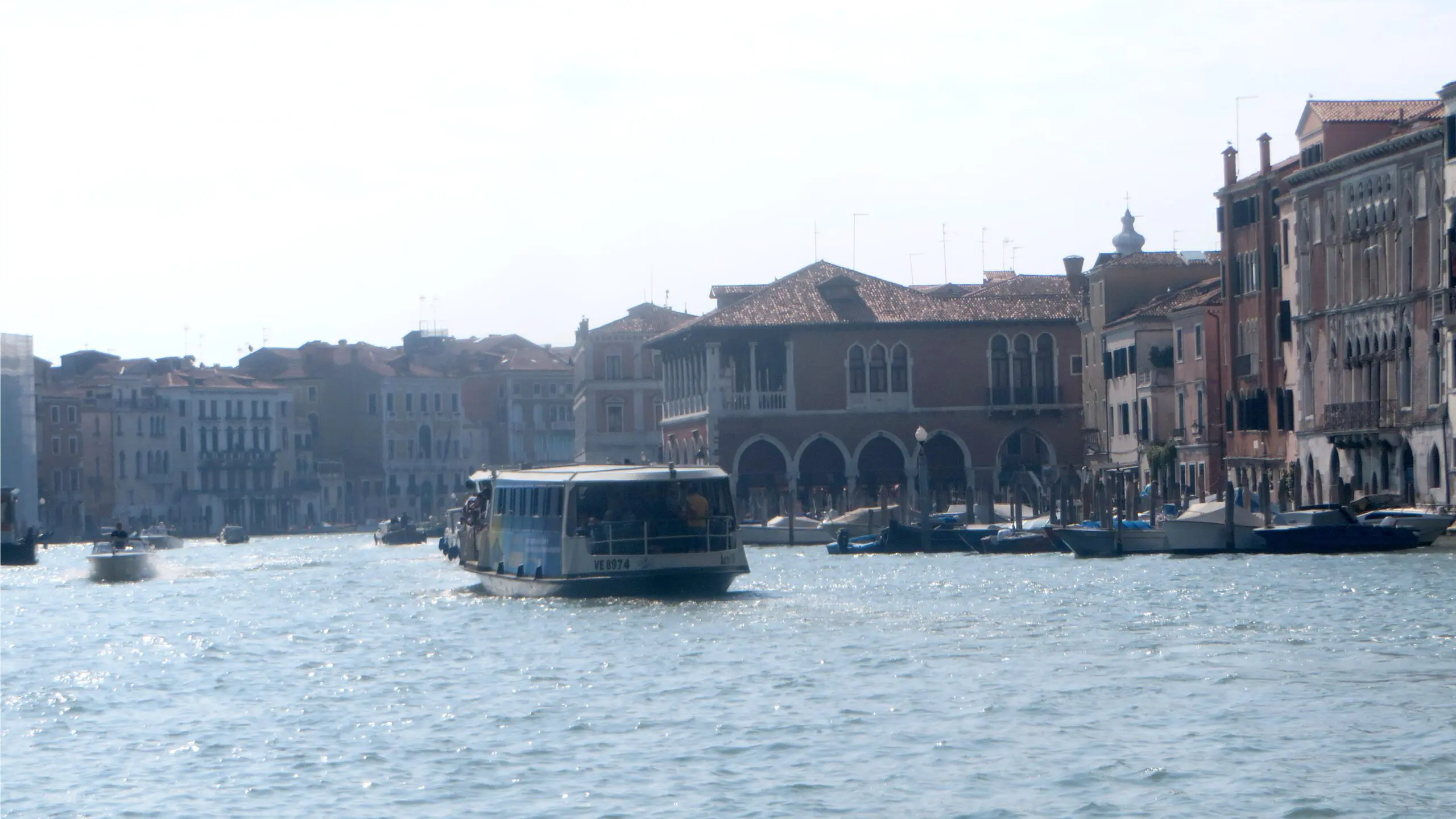 Real photograph of a public ACTV vaporetto waterbus traveling along Venice's Grand Canal